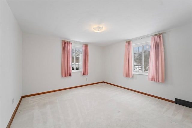 spare room with carpet flooring and a wealth of natural light