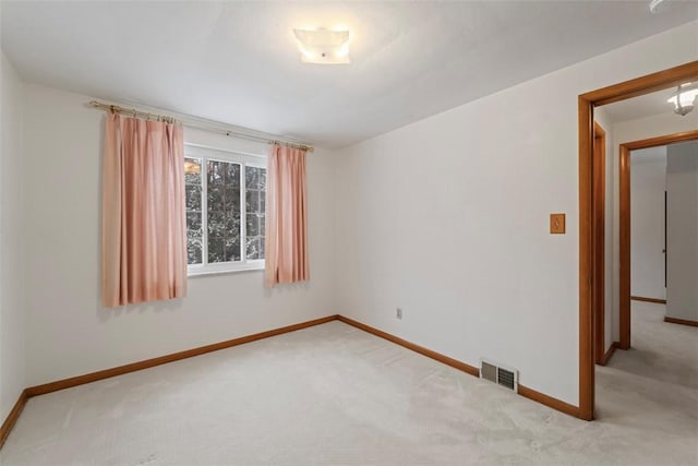 unfurnished room with light colored carpet