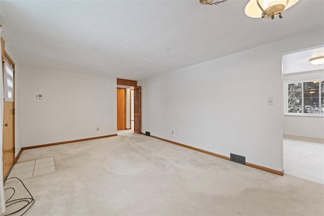 spare room featuring light carpet