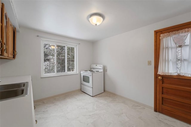 kitchen with white electric range oven and sink