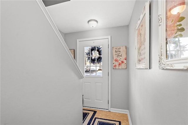 doorway to outside with tile patterned floors