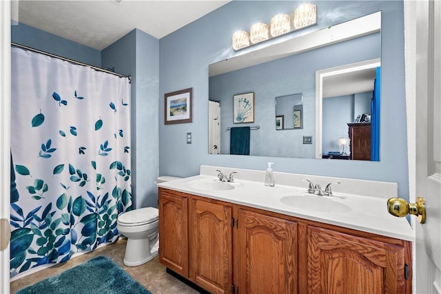 bathroom featuring vanity, toilet, tile patterned floors, and a shower with curtain