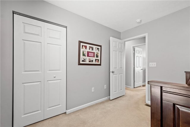 bedroom with light carpet and a closet