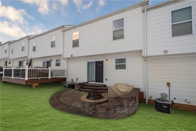 rear view of property featuring a patio area and a lawn