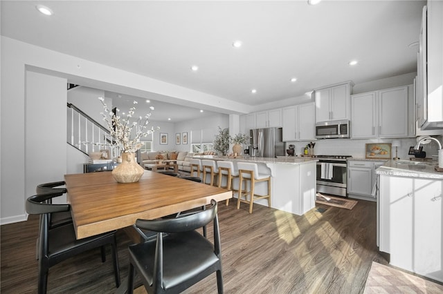 dining room with sink and dark hardwood / wood-style floors