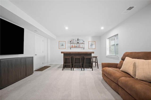 carpeted living room featuring indoor bar