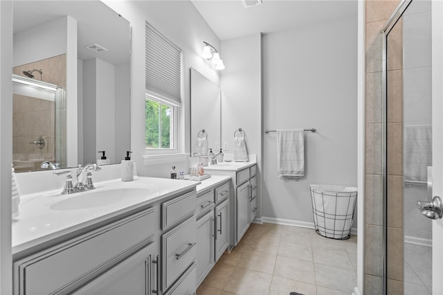 bathroom featuring a shower with door, tile patterned floors, and vanity