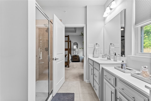 bathroom with tile patterned floors, an enclosed shower, and vanity