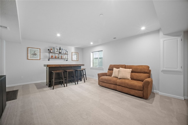 living room with light colored carpet and indoor bar