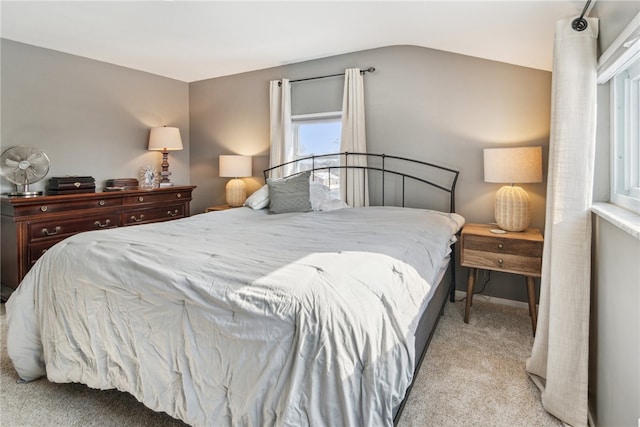 bedroom featuring vaulted ceiling and light carpet