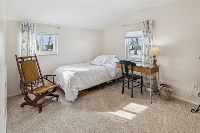 carpeted bedroom with multiple windows and lofted ceiling