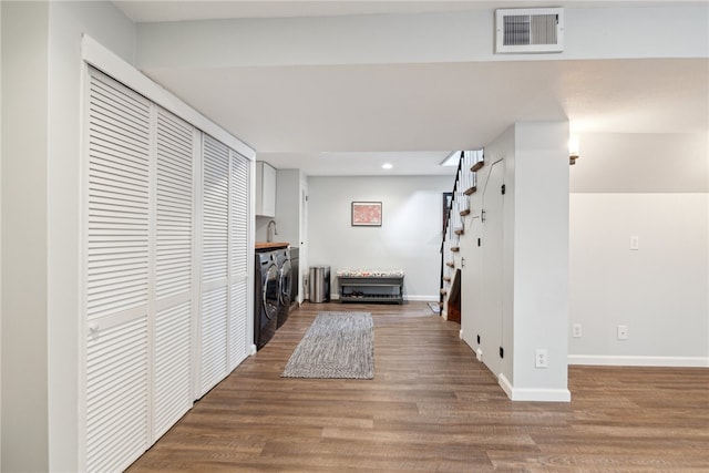 laundry room with sink, washer and clothes dryer, and hardwood / wood-style floors