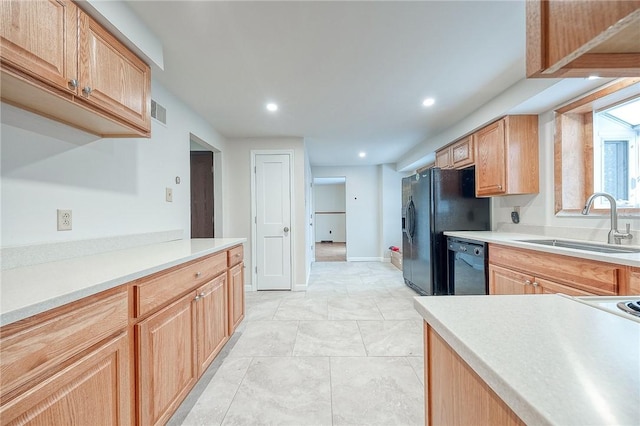 kitchen featuring sink, black appliances, and light tile patterned floors