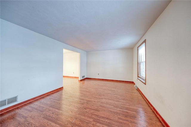 unfurnished room with hardwood / wood-style flooring