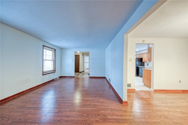 spare room featuring wood-type flooring