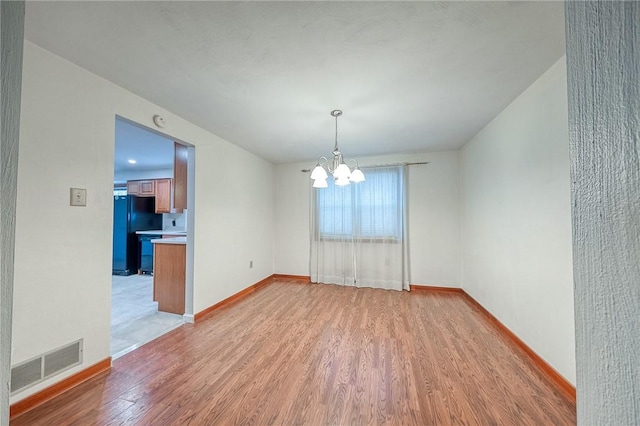 interior space featuring light hardwood / wood-style flooring and a chandelier