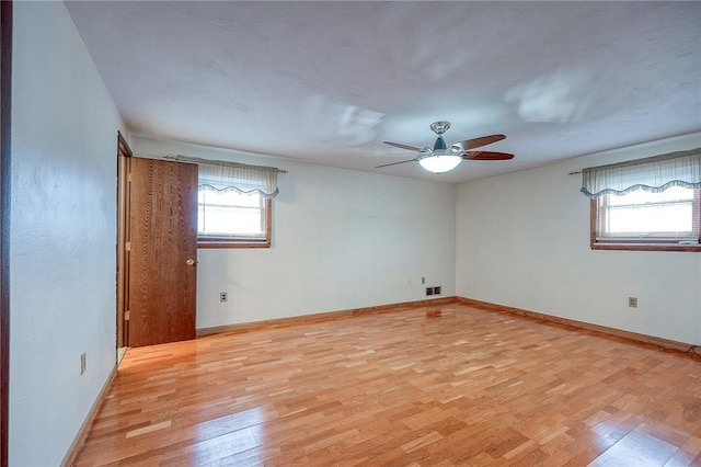 empty room with light hardwood / wood-style flooring and ceiling fan