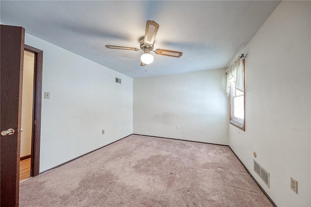 carpeted spare room featuring ceiling fan