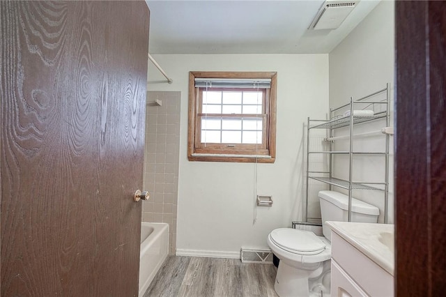 full bathroom with wood-type flooring, toilet, vanity, and shower / tub combination