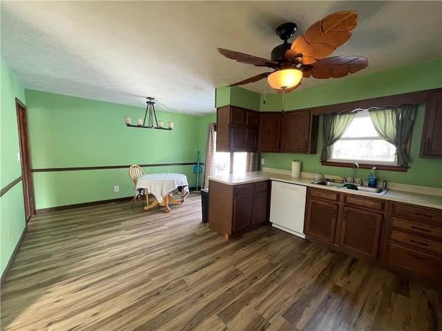 kitchen featuring dishwasher, hardwood / wood-style flooring, sink, dark brown cabinets, and ceiling fan with notable chandelier