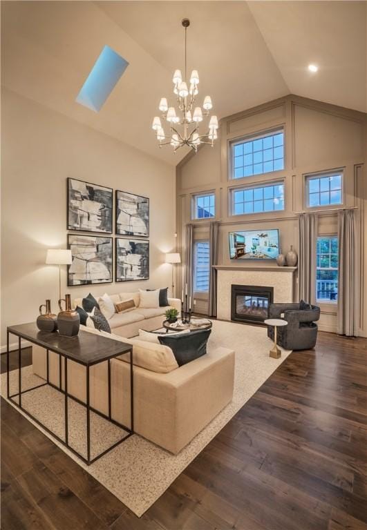 living room with a chandelier, high vaulted ceiling, and dark hardwood / wood-style flooring