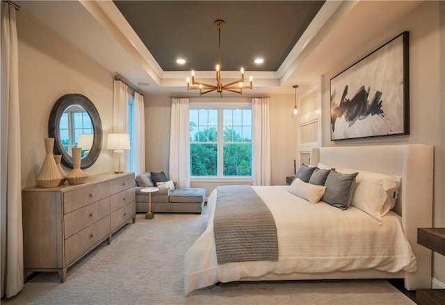 bedroom with a chandelier, a raised ceiling, and light carpet