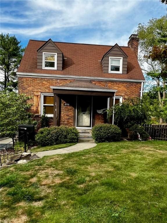 rear view of property with a lawn