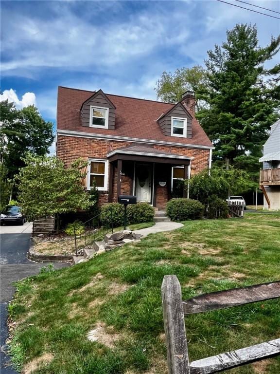 cape cod house with a front lawn