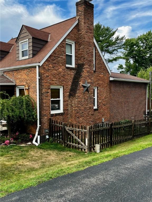 view of side of home featuring a yard