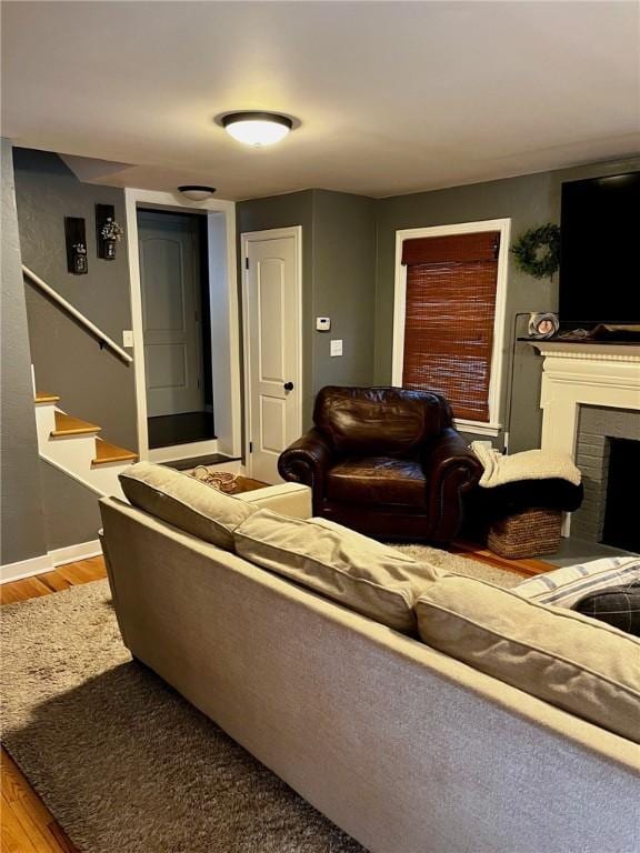 living room with light wood-type flooring and a fireplace