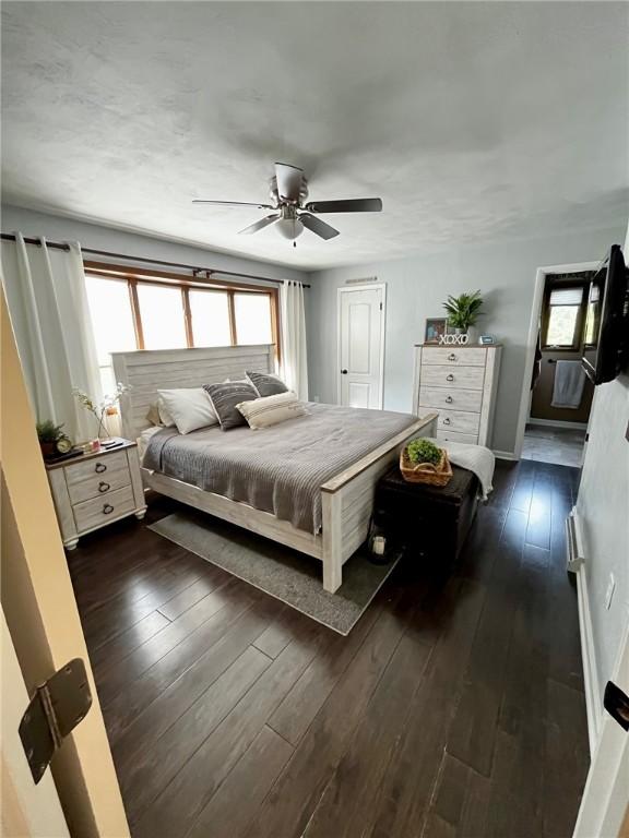 bedroom featuring ceiling fan and dark wood-type flooring