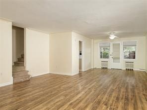 unfurnished living room featuring dark wood-type flooring and radiator