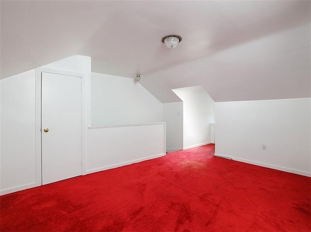 bonus room with carpet floors and lofted ceiling