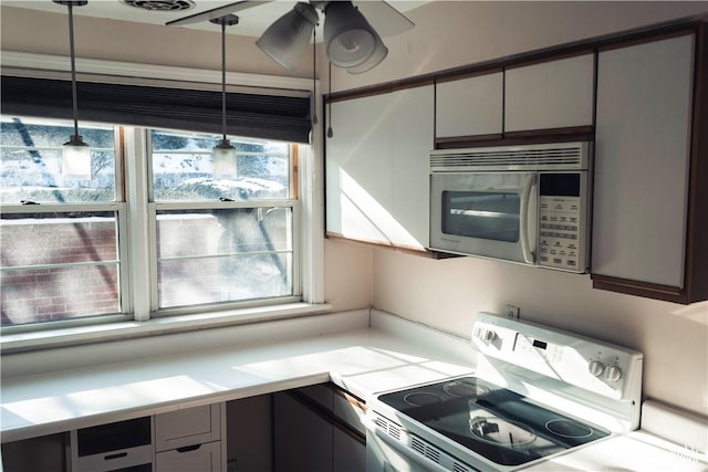 kitchen with decorative light fixtures, range with electric cooktop, and plenty of natural light