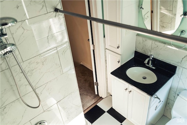 bathroom featuring walk in shower and vanity