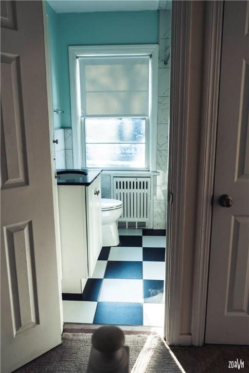 bathroom featuring toilet and radiator