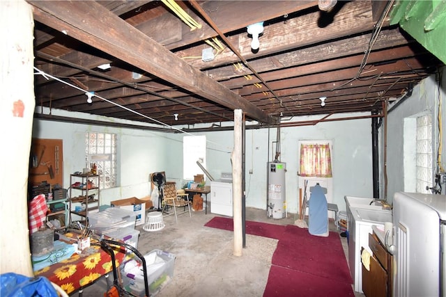 basement featuring washer and clothes dryer and water heater