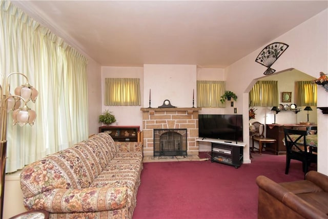 carpeted living room with a fireplace