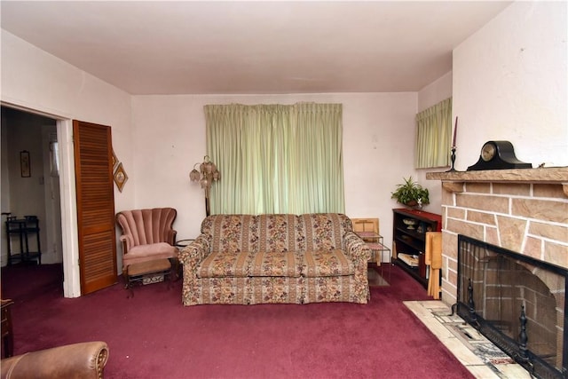 living room featuring dark colored carpet and a fireplace