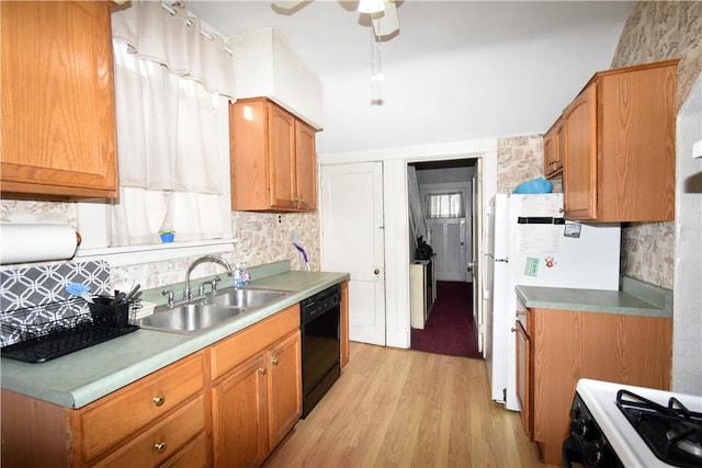 kitchen featuring gas stove, sink, tasteful backsplash, black dishwasher, and light hardwood / wood-style floors