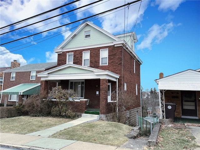 front of property with a porch and a front lawn