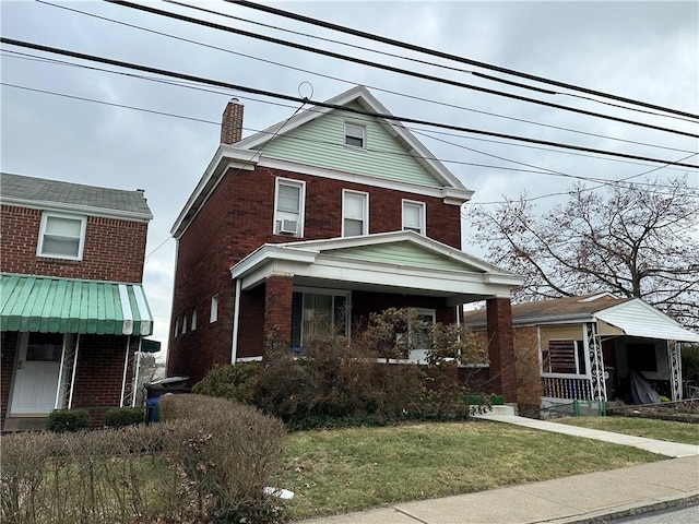 view of front of property featuring covered porch and a front lawn