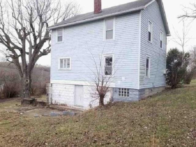 rear view of house with a lawn