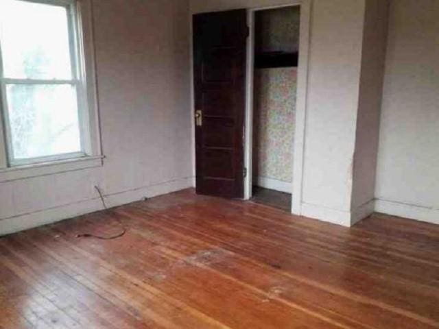 unfurnished bedroom featuring dark wood-type flooring