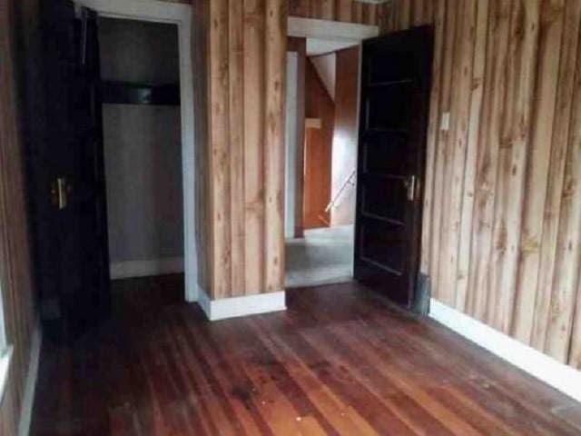 empty room featuring dark hardwood / wood-style flooring