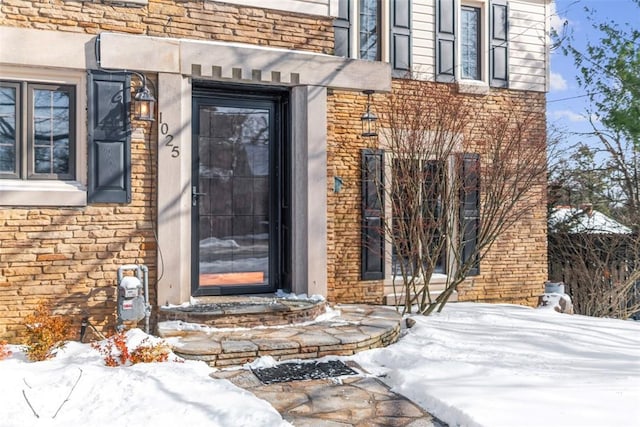 view of snow covered property entrance