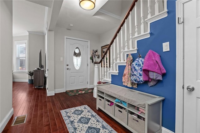 entrance foyer featuring crown molding and dark hardwood / wood-style flooring