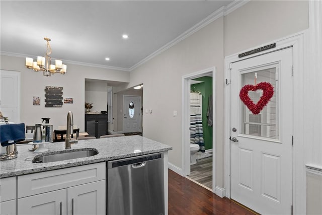 kitchen with light stone countertops, pendant lighting, white cabinets, sink, and stainless steel dishwasher