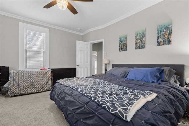 carpeted bedroom with crown molding and ceiling fan