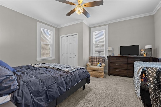 bedroom featuring a closet, ceiling fan, light carpet, and multiple windows